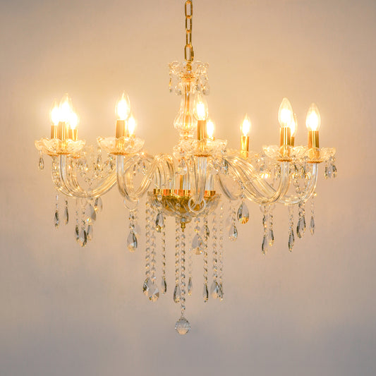A multi-arm crystal chandelier with gold-toned metal accents and hanging clear glass teardrop prisms, shown illuminated against a plain light background.