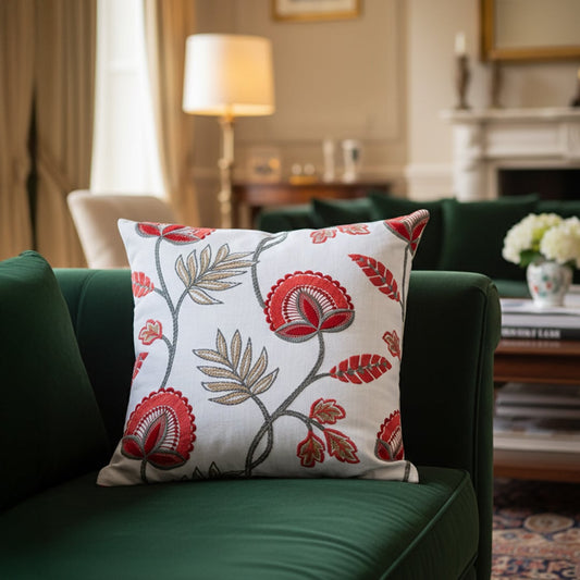 White cotton cushion cover with red floral print styled on a living room sofa for elegant modern home decor inspiration.