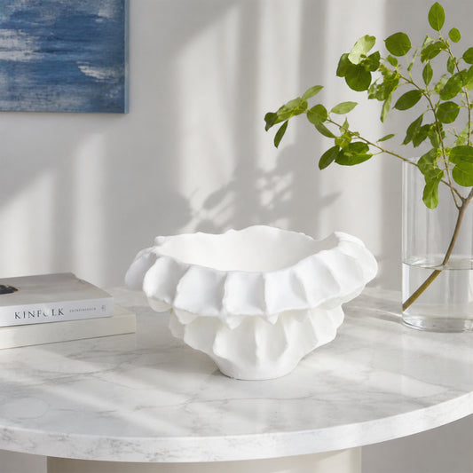 White textured ceramic planter bowl placed on marble table for elegant modern living room decor styling.