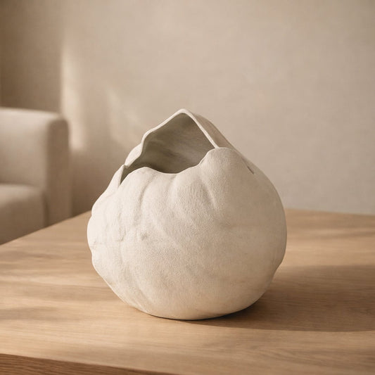 White ceramic decorative flower vase placed on wooden table minimal modern home decor styling idea.