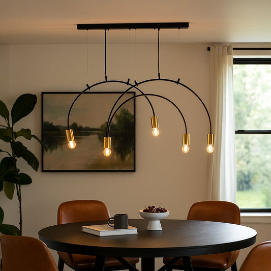 A modern black metal chandelier with gold holders glowing warmly above a round dining table creating a stylish contemporary ambience in a cozy home setting.