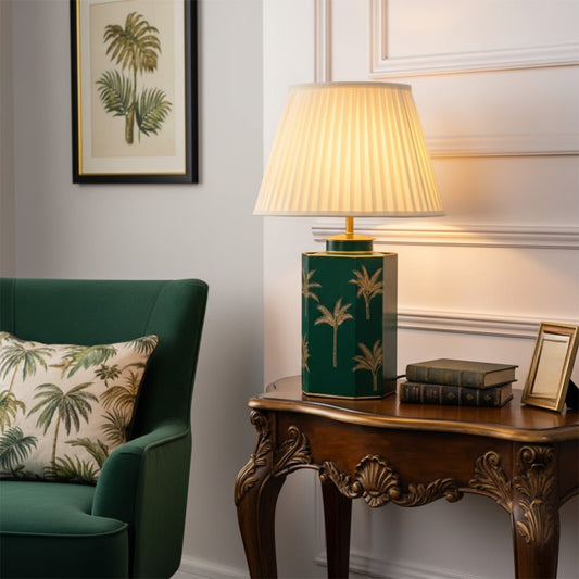Lifestyle image of blue metal table lamp with off white pleated shade for elegant bedroom decor styling and home lighting.