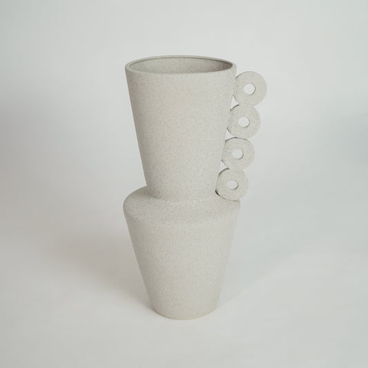 White ceramic decorative vase with sculptural loop handles for living room shelf on white background image.