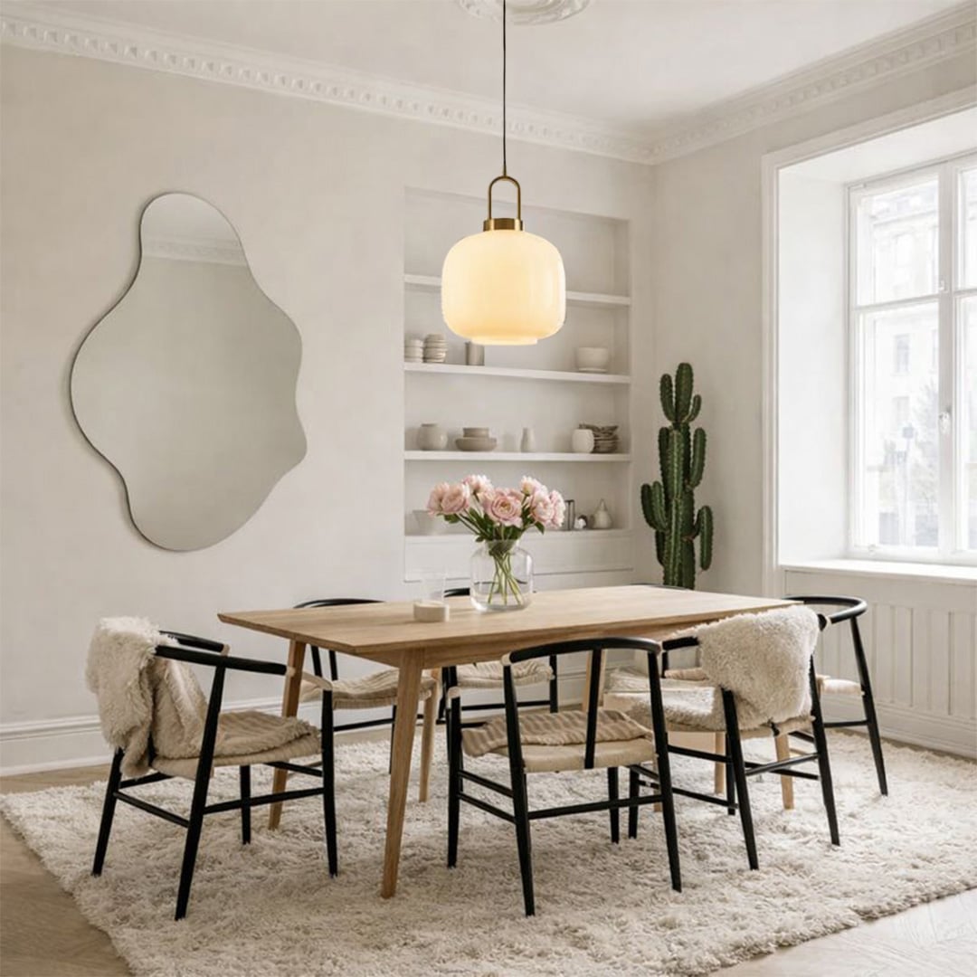 White glass and brass metal pendant light creating cozy elegance above the dining table in interiors.