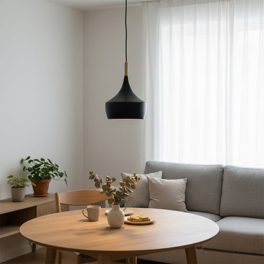 Black cone pendant light with wood accent above dining table adding elegant modern ambiance.
