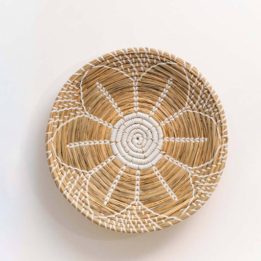 Handwoven seagrass round wall basket decor in natural beige with white spiral woven pattern displayed on white background.
