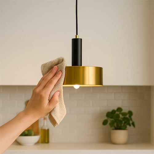 Modern kitchen pendant light cleaning process showing maintenance tips for shiny and long lasting lighting fixtures.
