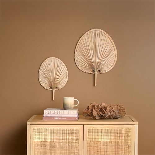 Wall basket decor styling with natural textures and boho elements creating warm and earthy home interior look.