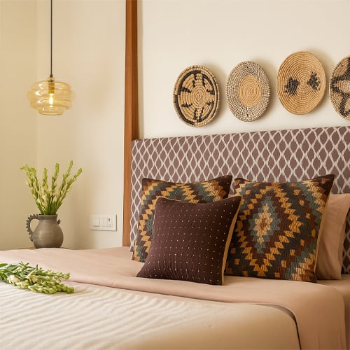 Decor setup with patterned cushions textures and wall accents creating balanced and stylish interior design ideas.