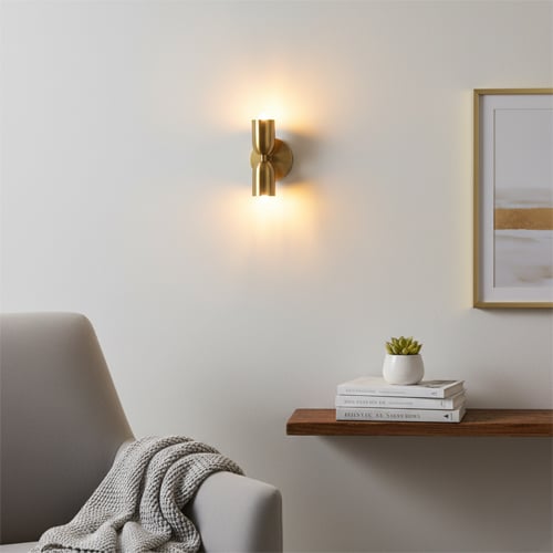 Up down wall light with warm glow on modern wall creating ambient lighting and stylish home decor effect.