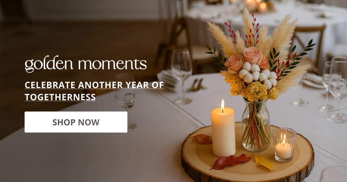 Anniversary decor styled with candles and floral arrangement creating warm romantic setup for special moments.