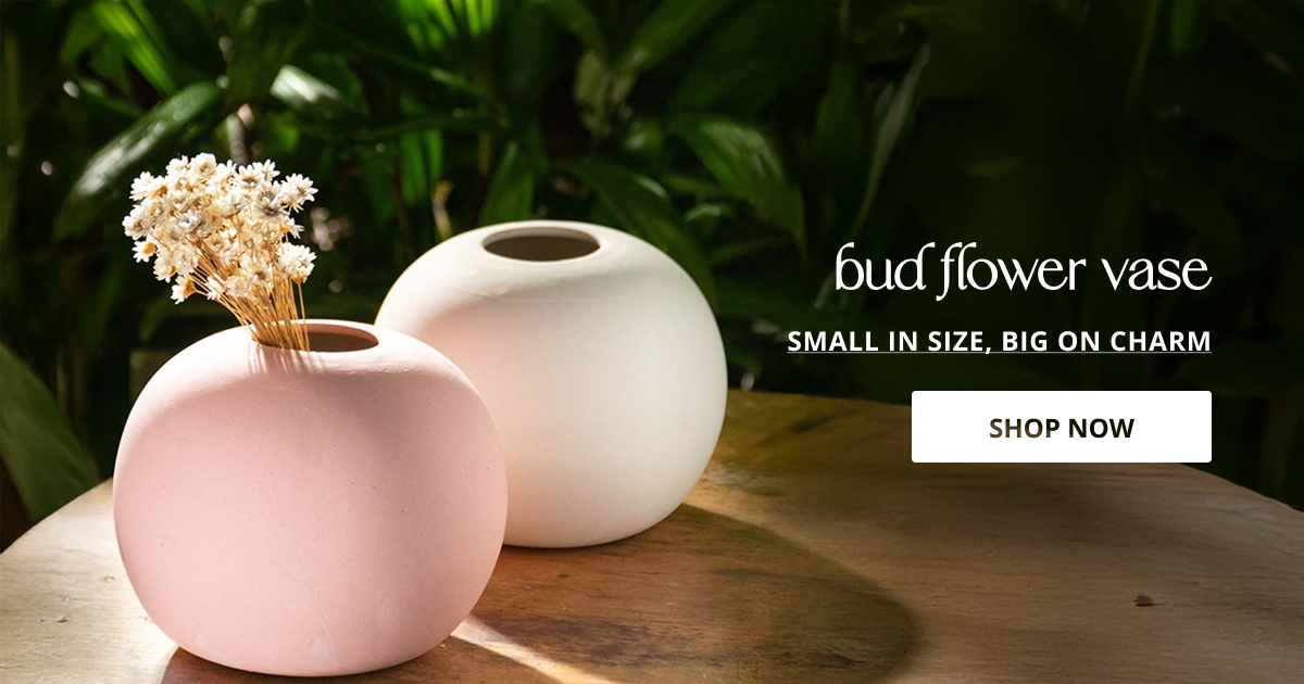Bud flower vase styled with minimal ceramic design placed on table creating soft modern decor look.