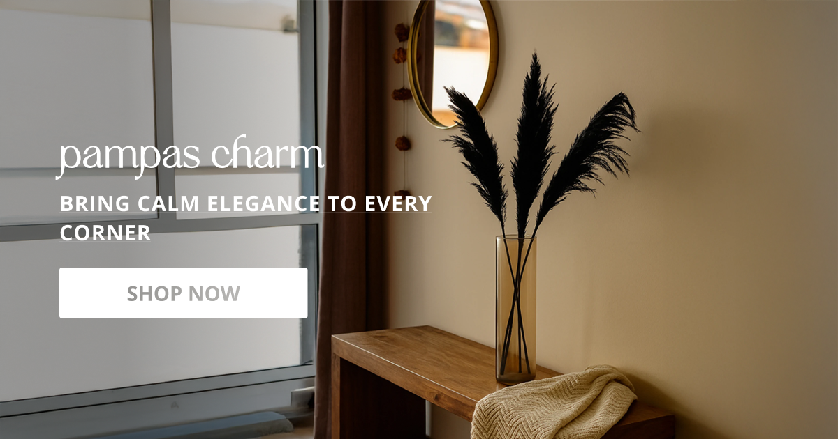 Decorative pampas grass styled in modern vase placed on wooden console creating warm aesthetic corner.
