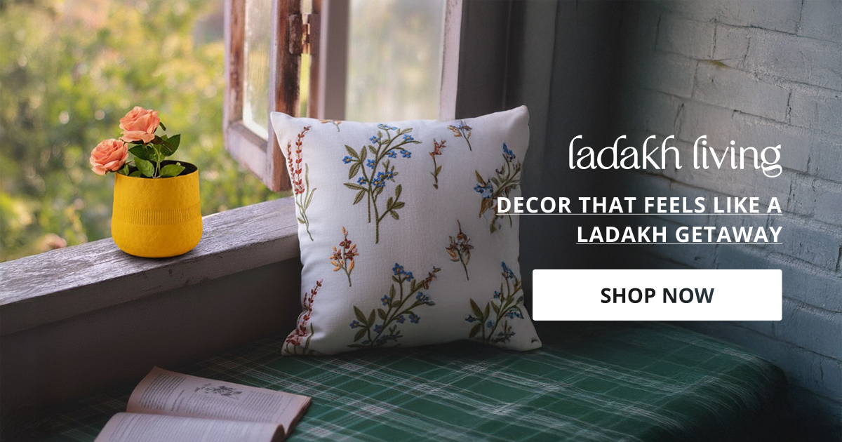 Home decor products inspired by Leh Ladakh featuring cozy window setup with cushion and plant.