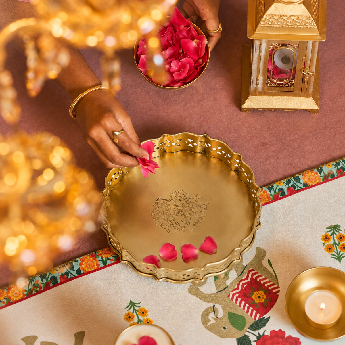 Luxury pooja room décor featuring brass trays, bowls and candle holders styled in an elegant traditional setting