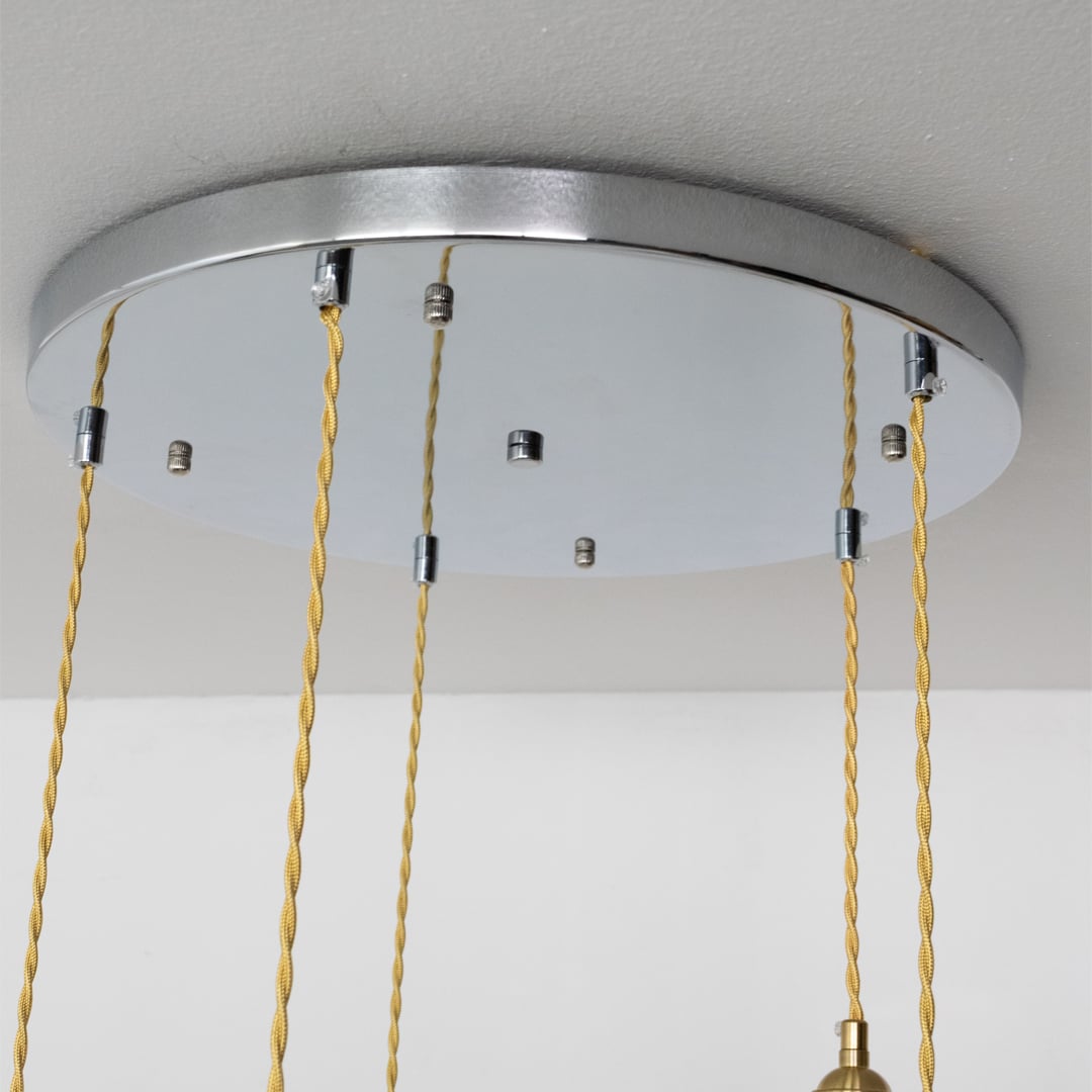 Silver metal round ceiling canopy with decorative chains highlighting refined craftsmanship and finish.