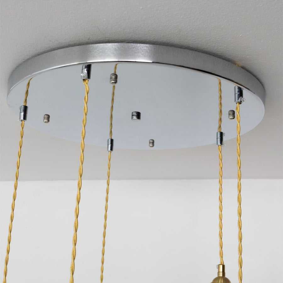 Silver metal round ceiling canopy with decorative chains highlighting refined craftsmanship and finish.
