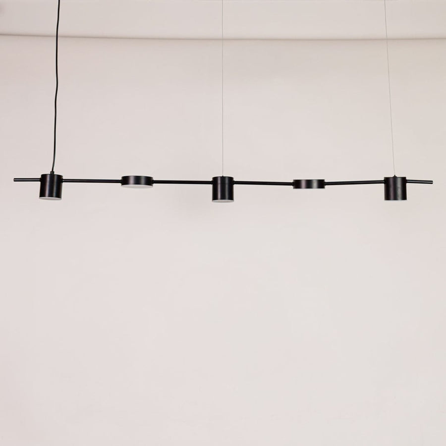 Black linear pendant light displayed unlit on white background with multiple adjustable heads for modern dining or kitchen lighting.