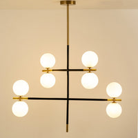 Frosted glass globe chandelier with gold and black metal frame designed for elegant modern ceiling lighting indoors.