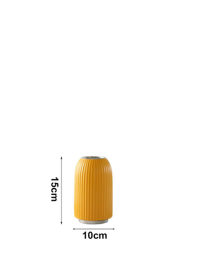 A yellow ribbed vase displayed with measurement markings showing 10 cm width and 15 cm height providing clear and accurate product dimensions.