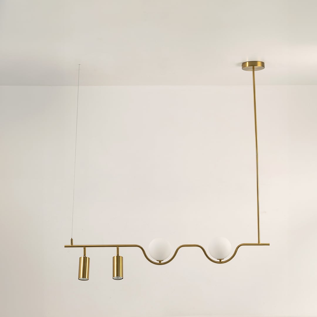 Gold metal linear chandelier on a white background with lights off highlighting its sculptural minimal modern form.