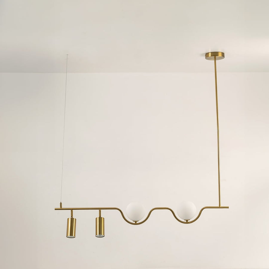 Gold metal linear chandelier on a white background with lights off highlighting its sculptural minimal modern form.