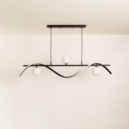 Black wave chandelier with white globe lights displayed off on a white background highlighting its sculptural design.