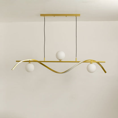 Gold metal wave chandelier with white globes displayed on a bright white background with lights switched off.