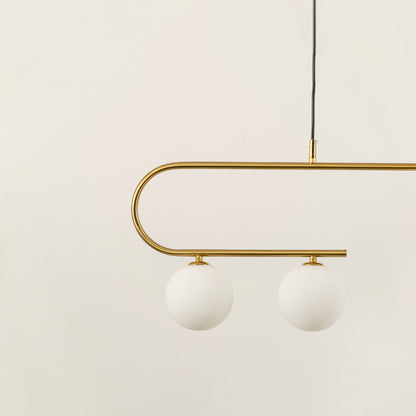 Gold metal chandelier with frosted glass globe shades highlighting premium craftsmanship and contemporary ceiling lighting.