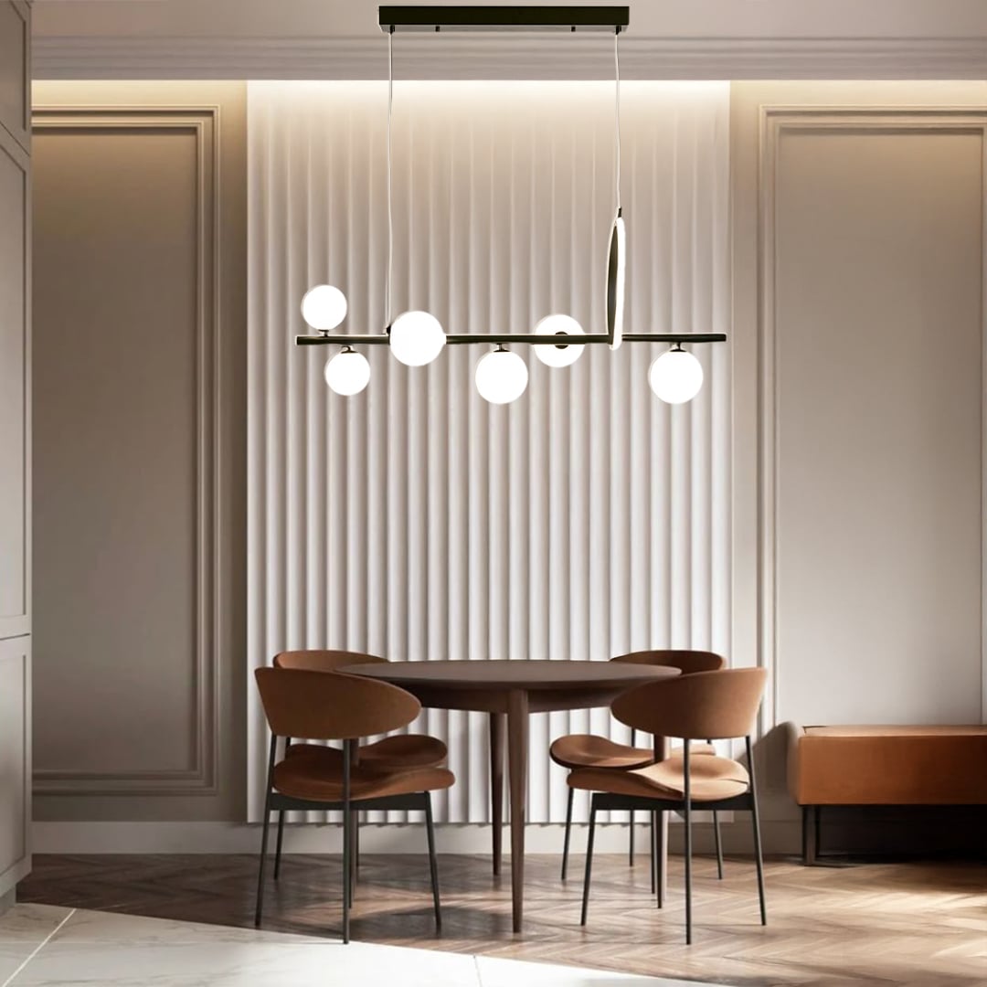 Black metal chandelier with frosted glass globes styled in a modern interior adding warm elegant ambient lighting to the room.