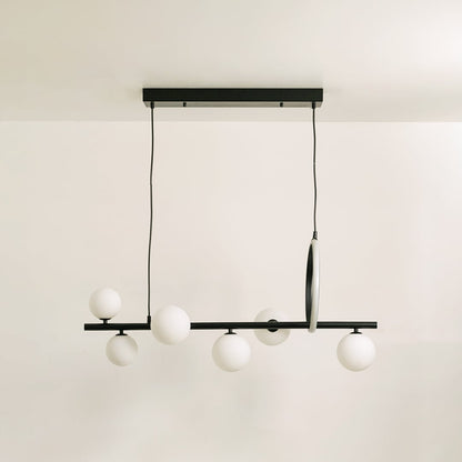 Black metal chandelier on a white background with the lights off highlighting its sculptural minimal silhouette.