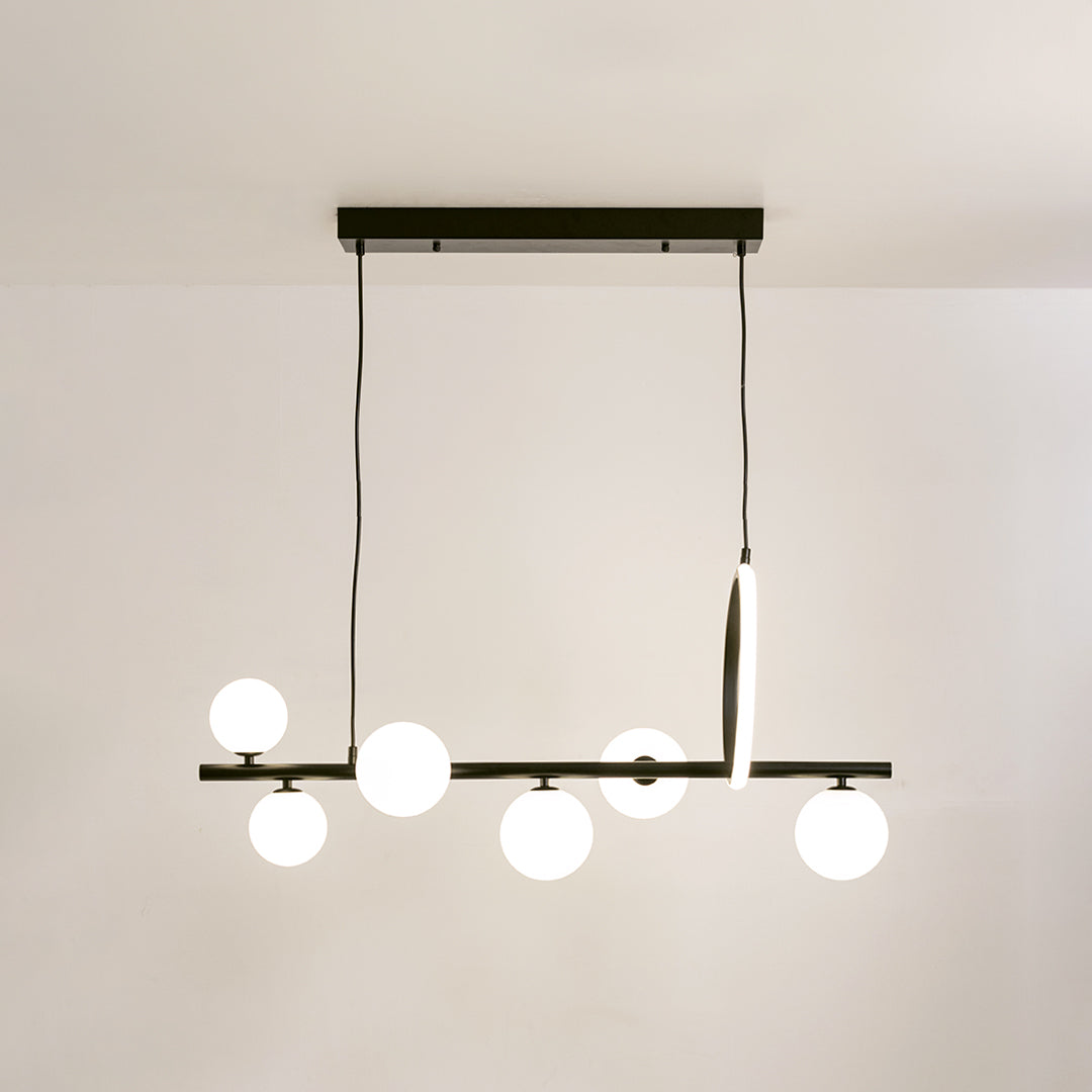 Black metal chandelier with frosted glass globe shades and integrated LED accent offering contemporary ambient lighting.
