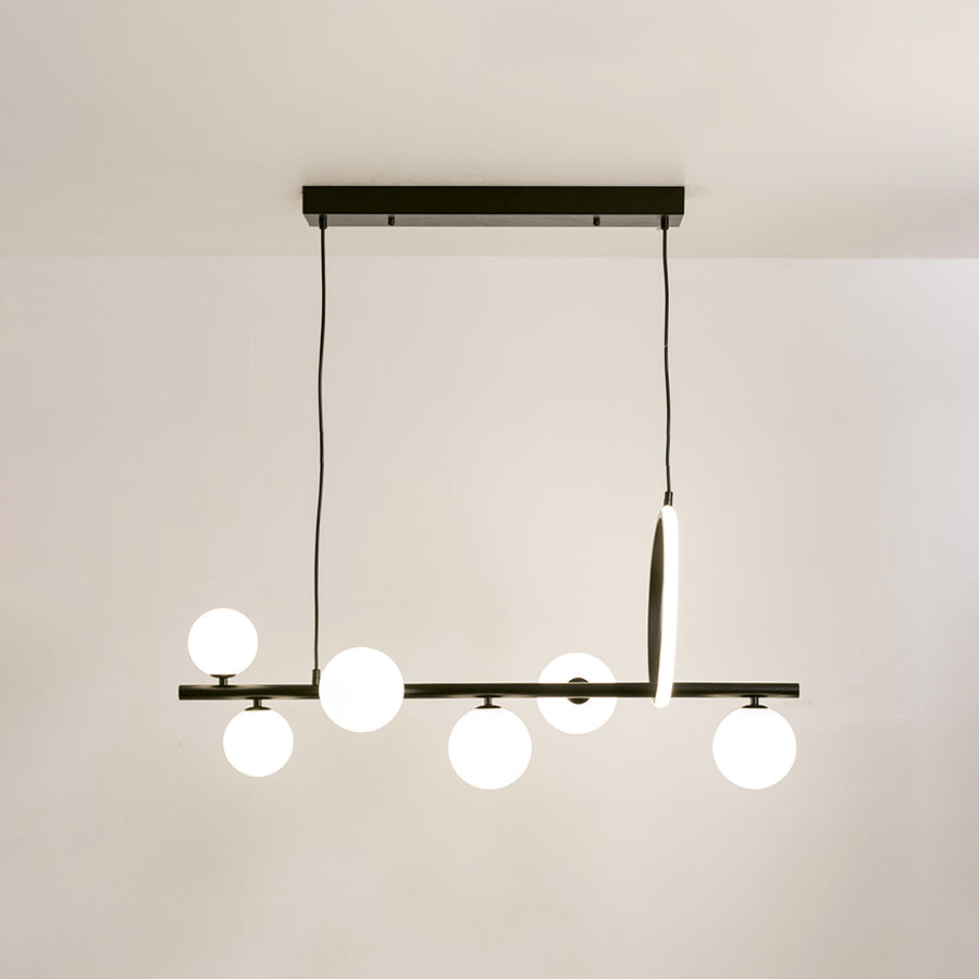 Black metal chandelier with frosted glass globe shades and integrated LED accent offering contemporary ambient lighting.