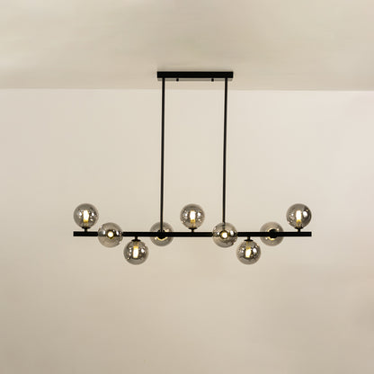 Smoked glass globe chandelier with illuminated glass shades creating sophisticated ambient lighting for modern interiors.