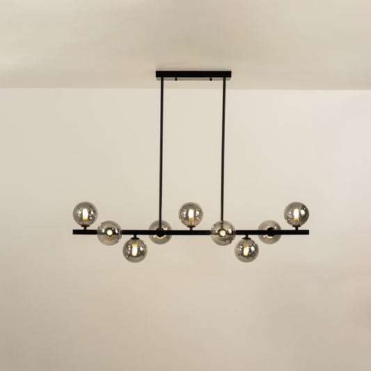 Smoked glass globe chandelier with illuminated glass shades creating sophisticated ambient lighting for modern interiors.