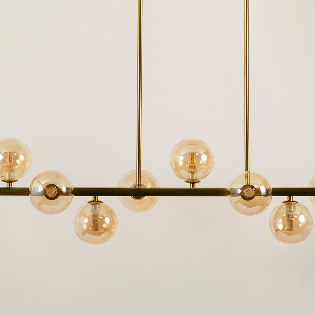 Amber glass globe chandelier with black metal frame showcasing elegant craftsmanship and modern decorative lighting.