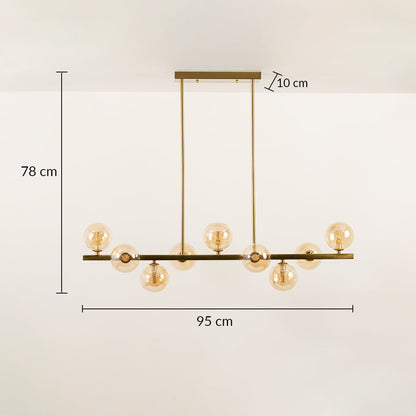 Gold ceiling chandelier with globe bulbs in a front view measuring 95 cm width and 78 cm height against a plain wall background with lights on perfect for luxury lighting décor.
