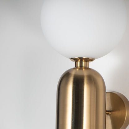 Detailed closeup view of brass wall sconce with frosted white glass shade premium indoor wall lighting for bedroom and hallway decor.