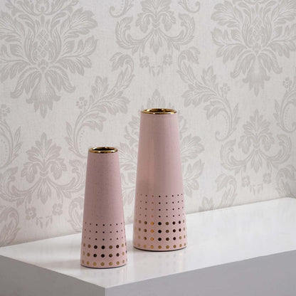 Pink ceramic vase with gold accents shown in a grouped decor setting highlighting its modern perforated design for elegant home styling.