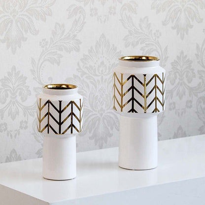 A decorative white and gold vase presented in a grouped setting highlighting its modern design and elegant finish for interior styling.