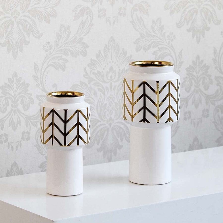 A decorative white and gold vase presented in a grouped setting highlighting its modern design and elegant finish for interior styling.