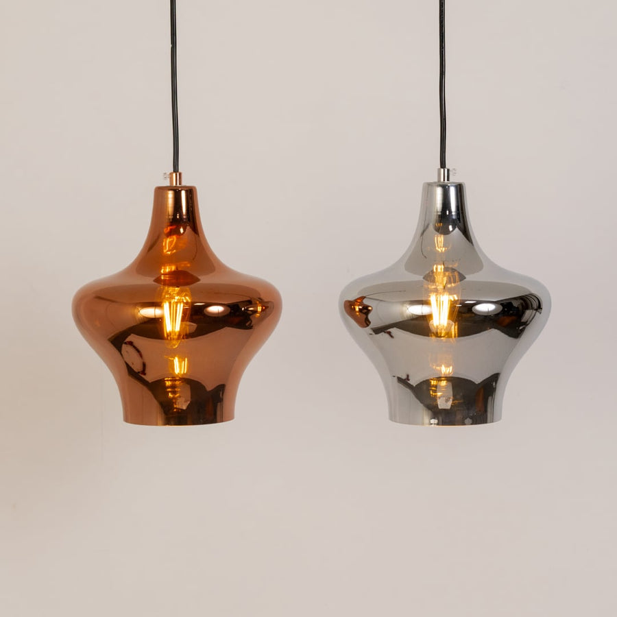 Modern chrome pendant light displayed in a grouped setup showing its elegant reflective design and smooth contoured shape clearly.