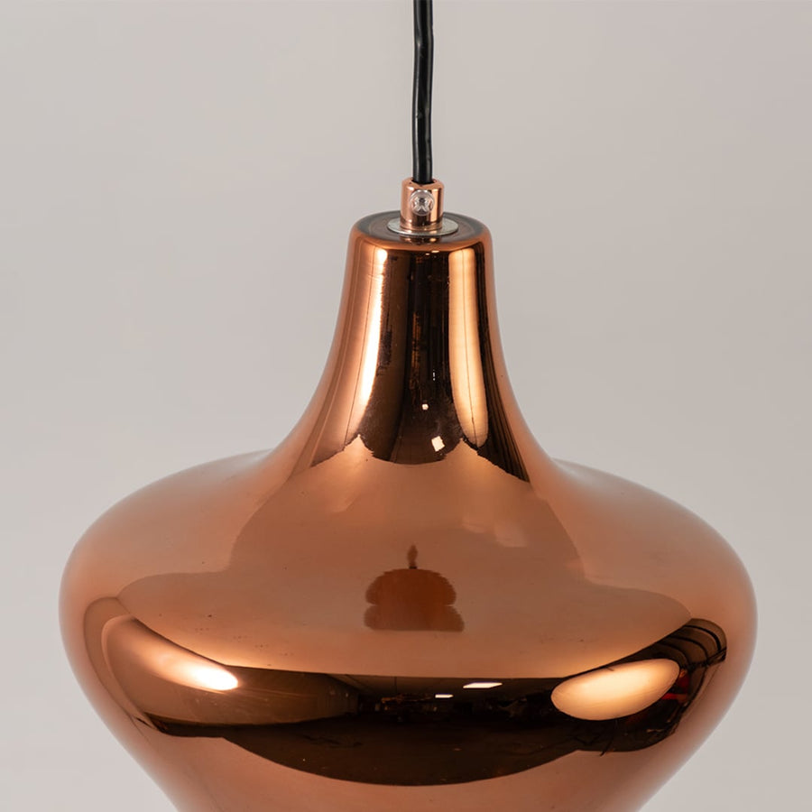 Copper metal pendant light closeup highlighting mirrored finish and premium contemporary lighting craftsmanship quality.