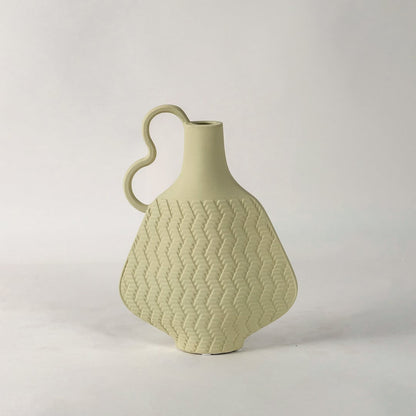 Minimal Haven beige vase on white background focusing on its organic shape modern wavy handle and soft handcrafted detailing.