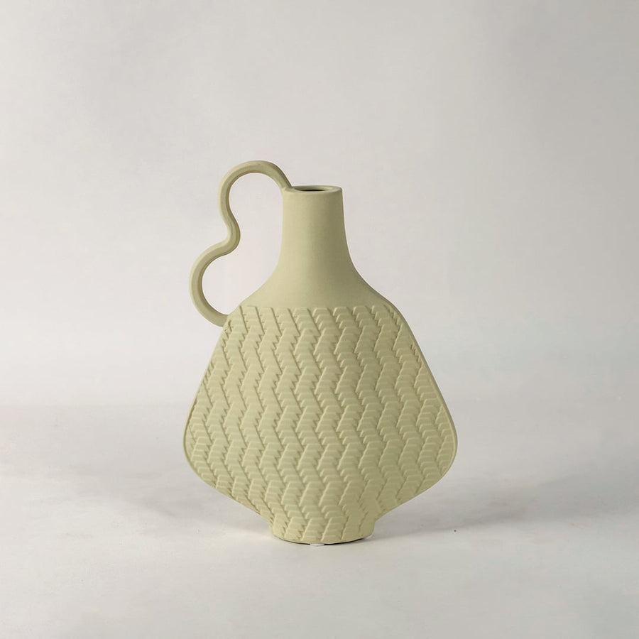 Minimal Haven beige vase on white background focusing on its organic shape modern wavy handle and soft handcrafted detailing.