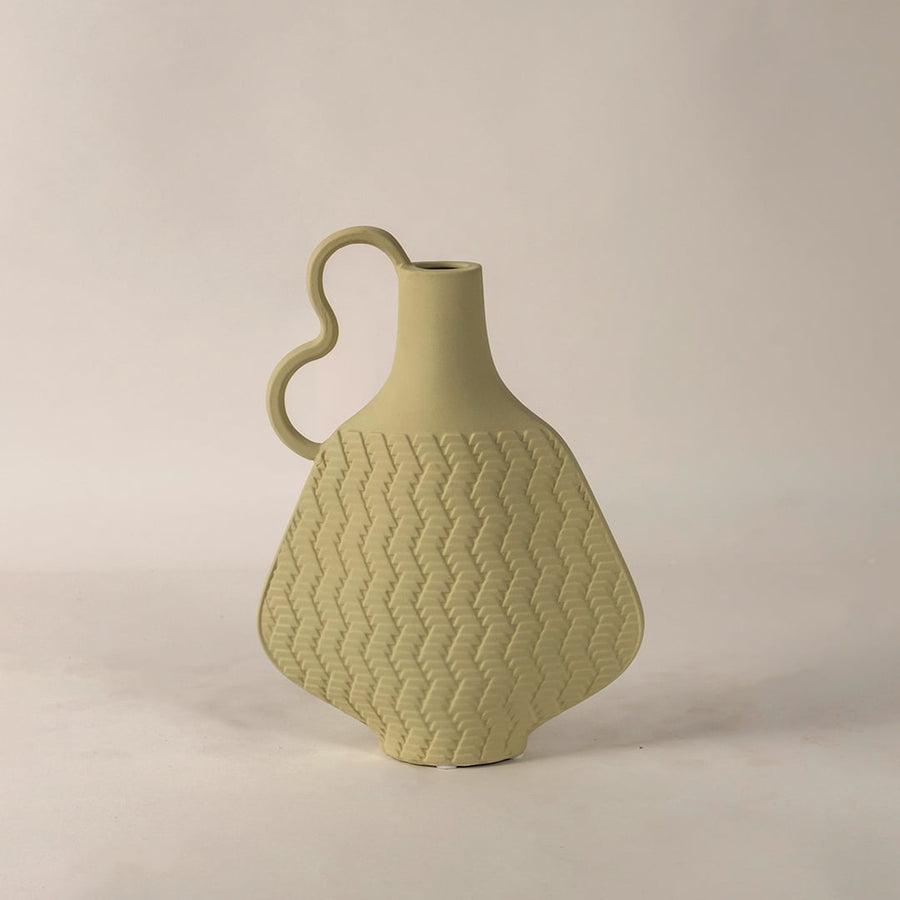 Haven beige ceramic vase displayed on a plain white background showcasing its wavy handle handcrafted woven texture and elegant matte finish.