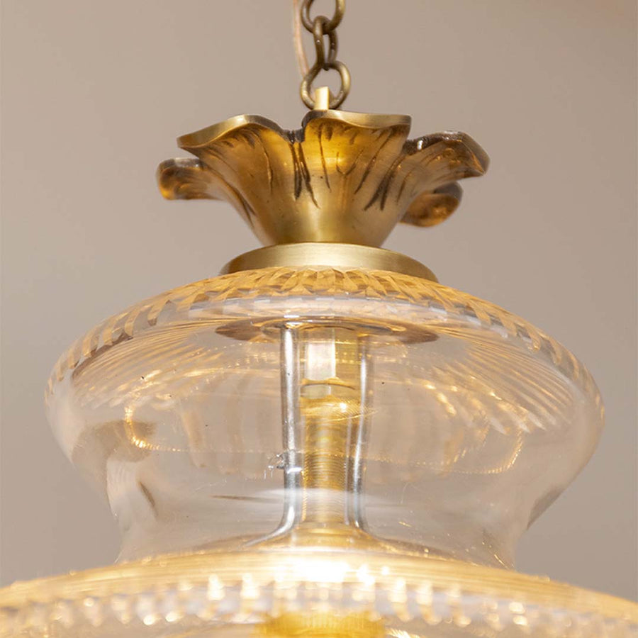 Detailed view of antique brass and textured glass lantern pendant light highlighting premium finish.