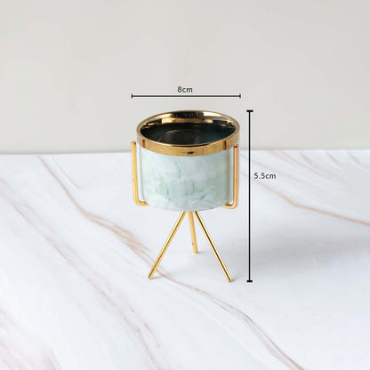 Mini marble planter on gold tripod stand showing dimensions 8 cm width and 5.5 cm height  displayed on a clean white marble background.