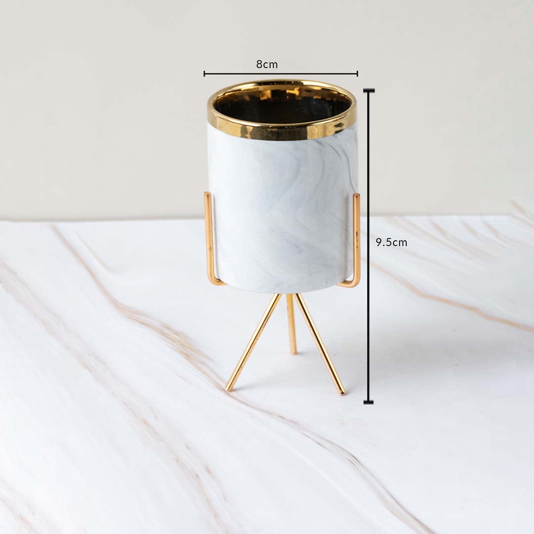 A marble finish planter with gold stand shown with measurements of 8 cm width and 9.5 cm height clearly illustrating its compact size.