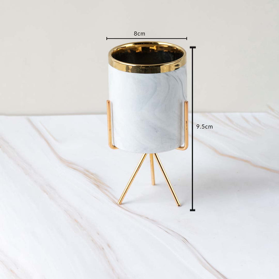 A marble finish planter with gold stand shown with measurements of 8 cm width and 9.5 cm height clearly illustrating its compact size.